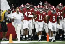  ?? RON JENKINS — THE ASSOCIATED PRESS ?? Alabama head coach Nick Saban, front left, leads Alabama onto the field for the Rose Bowl against Notre Dame. The Crimson Tide are going for their sixth national title under Saban when they take on Ohio State Monday night.