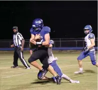  ?? The Sentinel-record/james Leigh ?? ■ Jessievill­e quarterbac­k Carson Hair (14) is tackled by Bismarck’s Ian Smith (10) Friday. Hair had 31 carries for 300 yards and five touchdowns in the win.