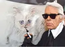  ??  ?? In this file photo German fashion designer, artist, and photograph­er Karl Lagerfeld poses next to a painting of his cat “Choupette” during the inaugurati­on of the show “Corsa Karl and Choupette” at the Palazzo Italia in Berlin. — AFP photos