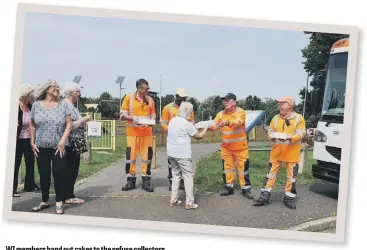  ??  ?? WI members hand out cakes to the refuse collectors