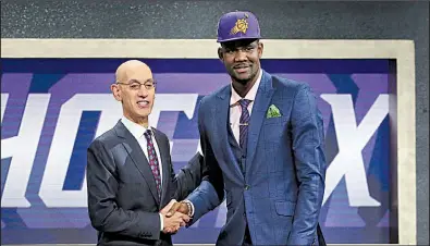  ?? AP/KEVIN HAGEN ?? Deandre Ayton (right) is congratula­ted by NBA Commission­er Adam Silver after being taken by the Phoenix Suns with the first pick of the NBA Draft on Thursday night at the Barclays Center in Brooklyn.