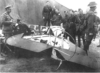  ??  ?? Bottom Right: Members of the Australian military show off pieces of wreckage from the Red Baron’s triplane on April 22, 1918. Some historians argue that an Australian fired the fatal bullet that killed the Red Baron.