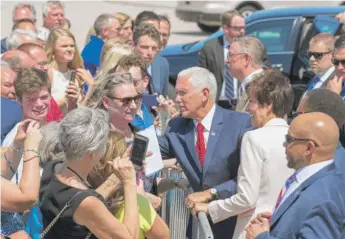  ?? JOSEPH CRESS/ THE DES MOINES REGISTER VIA AP ?? Vice President Mike Pence, with U. S. Rep. Rod Blum ( R- Iowa, to Pence’s right) and Iowa Gov. Kim Reynolds, meets supporters in Cedar Rapids, Iowa, on Wednesday.