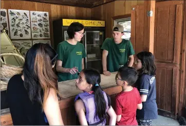  ?? PHOTO BY SAL PIZARRO ?? Counselors at Family Camp at Yosemite talk to young campers Sunday about plants and animals that can be found around the Tuolumne River at the campground’s nature center on Sunday.