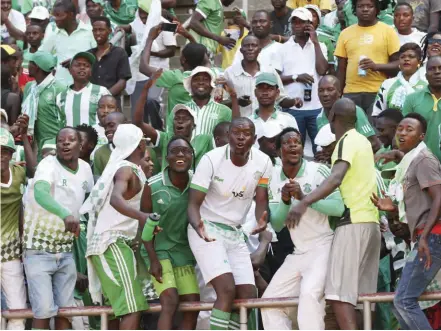  ?? ?? Caps United fans cheer their team on before the restrictio­n on the number of spectators.tif