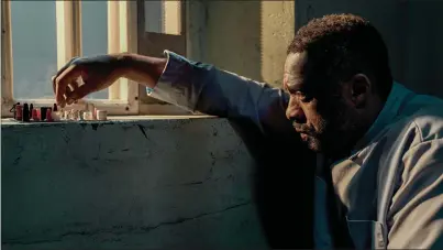  ?? NETFLIX ?? John Luther, played by Idris Elba, winds up in the slammer during the new movie “Luther: The Fallen Sun.”