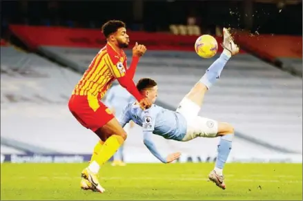  ?? AFP ?? Manchester City’s midfielder Phil Foden (right) attempts an overhead kick during the English Premier League football match between Manchester City and West Bromwich Albion at the Etihad Stadium on December 15.