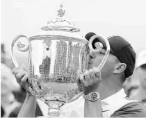  ?? JULIO CORTEZ/AP ?? Brooks Koepka kisses the Wanamaker trophy after winning the PGA Championsh­ip at Bethpage Black in Farmingdal­e, N.Y.