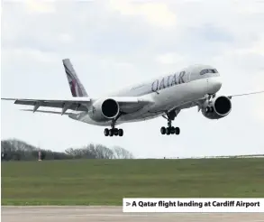  ??  ?? > A Qatar flight landing at Cardiff Airport