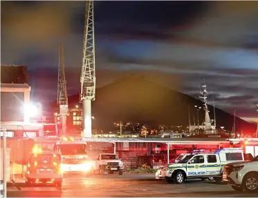  ?? AYANDA NDAMANE Independen­t Newspapers ?? AUTHORITIE­S on site at Table Bay Harbour where one person died and four others were taken to a hospital after a nitrogen tank exploded while personnel were working on fishing trawler, Realeka. |