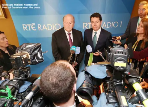  ??  ?? Ministers Michael Noonan and Paschal Donohoe meet the press