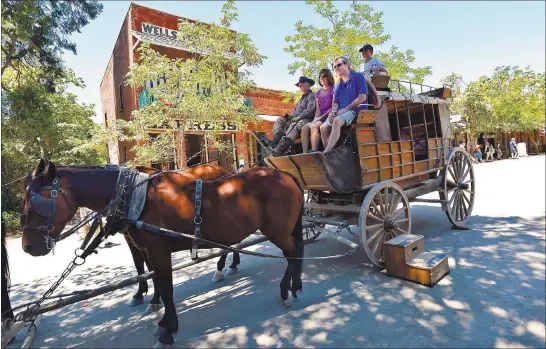  ?? DAN ROSENSTRAU­CH — BAY AREA NEWS GROUP ARCHIVE ?? A stagecoach prepares to take off from Main Street in Columbia State Historic Park in Columbia. The once-bustling Gold Rush town was the second biggest city in California at one point in the 19th century. The park hosts a variety of special events, including ghost walks and Gold Rush Days.