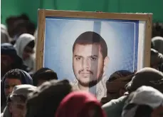  ?? EPA ?? From top, supporters carry a portrait of Houthi leader Abdel Malek Al Houthi; a boat carrying Houthi fighters; and a Houthi fighter on the Galaxy Leader ship seized by the group