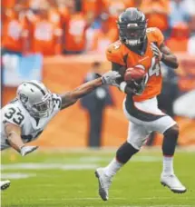  ?? Helen H. Richardson, The Denver Post ?? Denver’s Isaiah McKenzie eludes Oakland’s DeAndre Washington on a punt return Oct. 1.