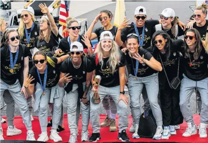  ?? REUTERS ?? U.S. women soccer players pose for a picture with the Trophy for the FIFA Women’s World Cup while the team arrives at the Newark Internatio­nal Airport, in Newark, New Jersey, U.S., July 8, 2019.