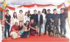  ??  ?? The AniHELP team with the K9 unit of the Royal Malaysia Police which trains service dogs to assist the police.