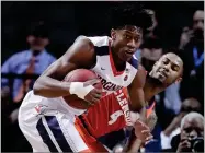  ?? AP PHOTO BY JULIE JACOBSON ?? In this March 9, 2018, file photo, Virginia guard De'andre Hunter (12) pulls down a rebound next to Clemson guard Shelton Mitchell (4) during an NCAA college basketball game in the semifinals of the Atlantic Coast Conference tournament in New York.