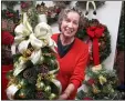  ?? SUBMITTED PHOTO ?? Dunwoody Village resident Lucia Englander shows one of the many floral arrangemen­ts that will be available for purchase at Dunwoody Village’s Holiday Bazaar, 9 a.m. to 3 p.m. Thursday, Nov. 21. The community is welcome.