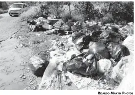  ?? RICARDO MAKYN PHOTOS ?? Garbage has been disposed of at the entrance to the Myersville disposal site in St Elizabeth.