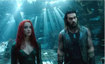  ??  ?? Aquaman (Momoa), right, with Mera (Amber Heard), tries to deliver sly buoyancy to the inelegantl­y scripted ‘Aquaman’, according to critics. — Courtesy of Warner Bros. Pictures