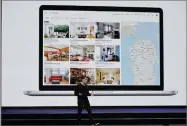  ?? AP FILE PHOTO BY ERIC RISBERG ?? In this Feb. 22, photo, Airbnb co-founder and CEO Brian Chesky speaks with San Francisco rental locations projected behind him during an event in San Francisco.