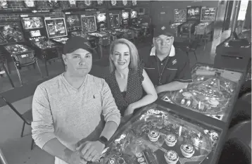  ?? JOE RONDONE/THE COMMERCIAL APPEAL ?? Partners Tony Westmorela­nd, from left, his wife Stephanie and David Yopp at their business the Flip Side: Memphis' first official pinball bar on Tuesday.