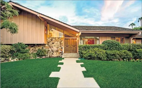  ?? Photograph­s by Anthony Barcelo ?? THIS STUDIO CITY house was used for outdoor depictions of the Brady family’s abode. Interior scenes were filmed in studio.