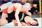  ?? Christian Abraham / Hearst Connecticu­t Media ?? Ridgefield’s Alex Blaha, left, battles Trumbull’s Michael Longo in the 106-pound finals at the Class LL wrestling championsh­ips.