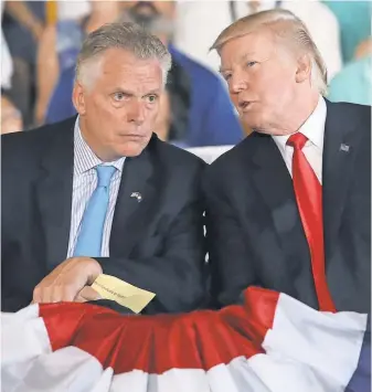  ?? MARK WILSON, GETTY IMAGES ?? Virginia Gov. Terry McAuliffe, left, with President Trump, wants to shift Democrats’ focus, with particular emphasis on governor elections.