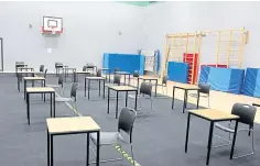  ??  ?? Head caretaker Brian Smith spaces out the desks.