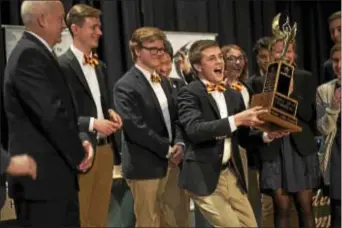  ?? RICK KAUFFMAN – DIGITAL FIRST MEDIA ?? Haverford High School Hi-Q captain, Jack McGovern, 18, gleefully hoists the championsh­ip trophy for the Hi-Q victory Haverford earned over Garnet Valley and Radnor.