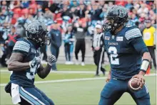  ?? COLE BURSTON THE CANADIAN PRESS ?? Argonauts quarterbac­k James Franklin, right, celebrates his touchdown with teammate Brandon Burks during first-half CFL action against the Montreal Alouettes in Toronto on Saturday. Toronto won, 26-22.