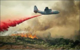  ?? AP PHOTO/JOSH EDELSON ?? A U.S. Air Force plane drops fire retardant on a burning hillside in the Ranch Fire in Clearlake Oaks, Calif., Sunday.