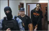  ?? EVGENIA NOVOZHENIN­A — POOL PHOTO VIA AP ?? American basketball star Brittney Griner, right, is escorted Wednesday to a courtroom in Khimki, Russia.