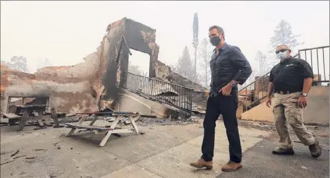  ?? Christophe­r Chung / Associated Press ?? California Gov. Gavin Newsom arrives at Foothills Elementary School while touring areas damaged by the Glass Fire near St. Helena, Calif., Thursday.