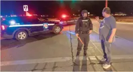  ?? MIKE ROEMER/AP ?? A Wisconsin State Patrol officer blocks the road Saturday in front of the Oneida Casino in Green Bay, after reports of an active shooter.