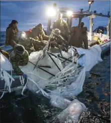  ?? U.S. NAVY VIA AP ?? In this photo provided by the U.S. Navy, sailors assigned to Explosive Ordnance Disposal Group 2recover a high-altitude surveillan­ce balloon off the coast of Myrtle Beach, S.C., on Feb. 5.