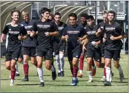  ?? MATT BATES — ENTERPRISE-RECORD ?? Senior Cooper Renteria, center, and the Chico State men’s soccer team warms up before practice on Wednesday in Chico.