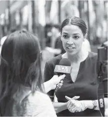  ?? MARY ALTAFFER/THE ASSOCIATED PRESS ?? Alexandria Ocasio-Cortez, right, is the 28-year-old political newcomer who upset U.S. Rep. Joe Crowley in New York’s Democrat primary on Monday. Ocasio-Cortez says she brings an “urgency” to the fight for working families.