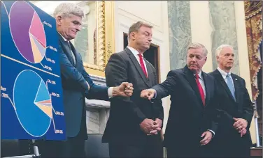  ?? AP/ANDREW HARNIK ?? Sens. Bill Cassidy (left), R-La., and Lindsey Graham, R-S.C., exchange a fist bump Wednesday as they and fellow GOP Sens. Dean Heller (second from left) of Nevada and Ron Johnson of Wisconsin unveil their health care plan on Capitol Hill.