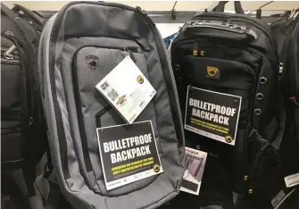  ?? AP ?? STAYING SAFE: Bulletproo­f backpacks are for sale at an Office Depot store in Evanston, Ill.