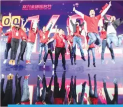  ??  ?? SHANGHAI: Alibaba staff pose for photos in front of a screen showing total sales at over 168 billion yuan shortly after the end of the 11.11, or Singles Day shopping festival, at a gala event in Shanghai early yesterday.