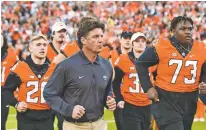  ?? BRODY SCHMIDT/ASSOCIATED PRESS FILE PHOTO ?? Oklahoma State coach Mike Gundy takes the field for the team’s Oct. 30 game against Kansas in Stillwater, Okla. Oklahoma State plays Oklahoma at 5:30 p.m. Saturday.