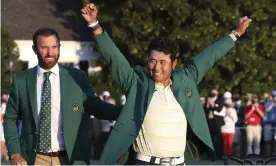  ?? Photograph: Curtis Compton/AP ?? Hideki Matsuyama celebrates in the champion’s Green Jacket at Augusta while the 2020 champion Dustin Johnson (left) looks on.