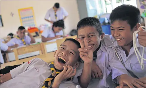  ??  ?? HAPPY DAYS: School children born to migrant workers at Wat Sri Suttharam School in tambon Bang Ya Praek of Samut Sakhon’s Muang district laugh and play together during classroom activities at the school.
