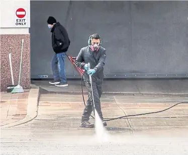  ?? ANDREW FRANCIS WALLACE TORONTO STAR FILE PHOTO ?? A worker power-washes the exit to an undergroun­d parking lot on Yonge Street. “Deep cleaning is not a technical term,” one cleaning expert warns. Instead, it might mean more thorough cleaning on an ongoing basis.