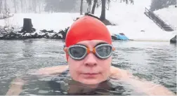  ??  ?? TOUGH AS NAILS Karen enjoys a swim in freezing water in Estonia