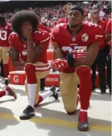  ?? NHAT V. MEYER/TRIBUNE NEWS SERVICE ?? Quarterbac­k Colin Kaepernick, left, and Eric Reid kneel during the national anthem before their NFL game against the Dallas Cowboys on Oct. 2, 2016.