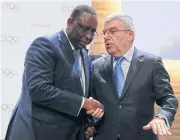  ?? REUTERS ?? Senegalese President Macky Sall, left, shakes hands with IOC chief Thomas Bach.