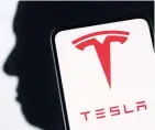  ?? REUTERS ?? The Tesla logo and Elon Musk silhouette are seen in this illustrati­on.